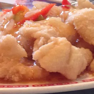 The crispy fish is in a ginger, vinegar mildly sweet sauce with mild heat.