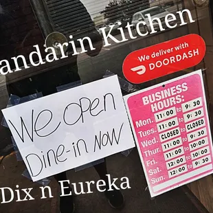 a man holding a sign in front of a door