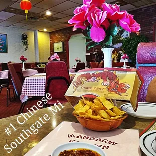 a table with a bowl of chili and a bowl of chips