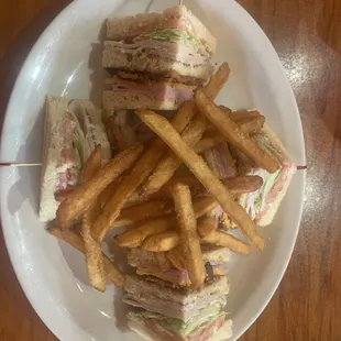 a plate of sandwiches and french fries