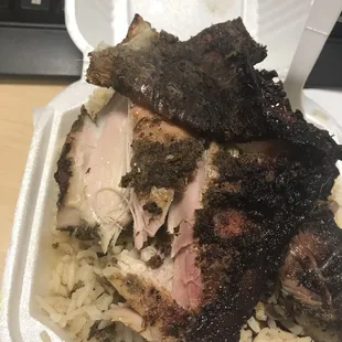 Jerk chicken over rice and peas