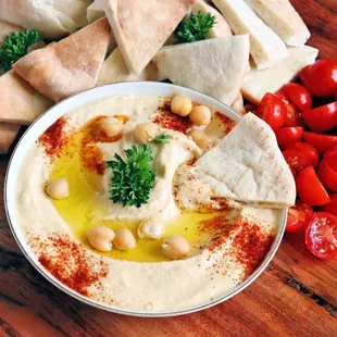 a bowl of hummus and pita chips