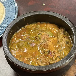 a bowl of soup and a plate of bread