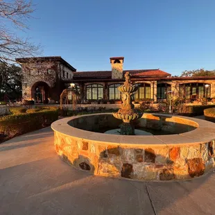 a fountain in front of a house