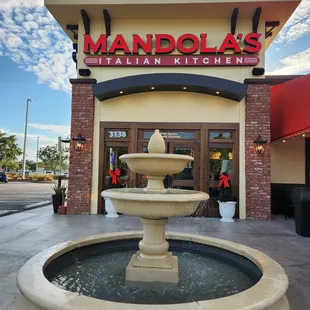 a fountain in front of a restaurant