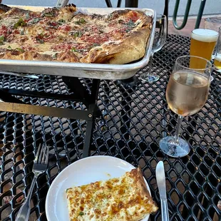 a plate of pizza and a glass of wine