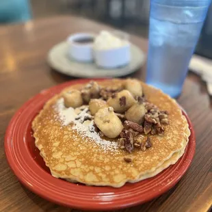 a plate of pancakes and a glass of water