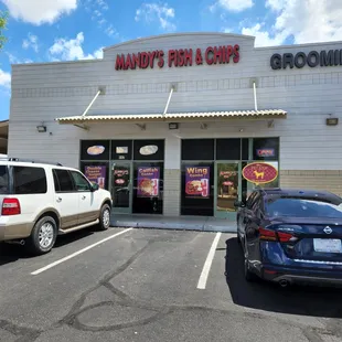 two cars parked in front of the store