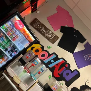 a display of t - shirts and a vending machine