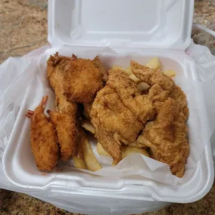 fried chicken and fries in a styrofoam container