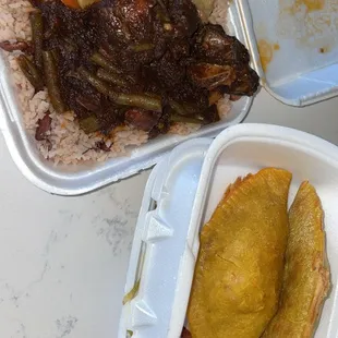 Oxtail, rice and beans, and cabbage stew plate. Beef Pattie&apos;s and ripe plantains.