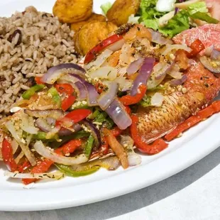 a plate of fish, rice, and vegetables