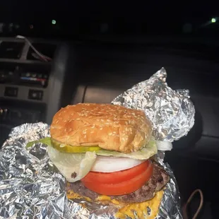 a hamburger wrapped in tin foil