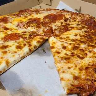 Half pepperoni cheese pizza at home after picking up to go. Sooooo good!