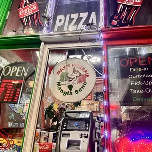 Storefront incorporating an ATM in the window.  Nothing more Italian authentic than no credit, cash only