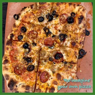 a pizza with olives and cheese