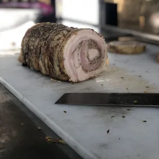 Porchetta - pork tenderloin wrapped in a pork belly, slow roasted with lettuce and tomato on brioche