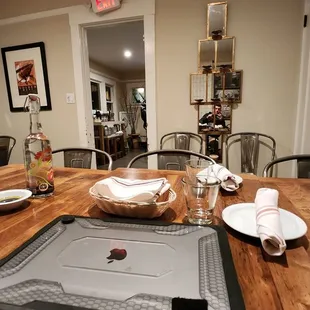 a dining table with a pizza on it