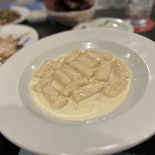 a bowl of pasta and other dishes on a table