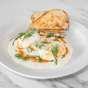 Cilibir (Turkish Eggs)
Poached eggs on a bed of yogurt with fresh herbs and spiced brown butter
