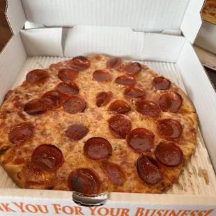 a pepperoni pizza in a box