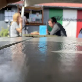 people sitting at a table outside