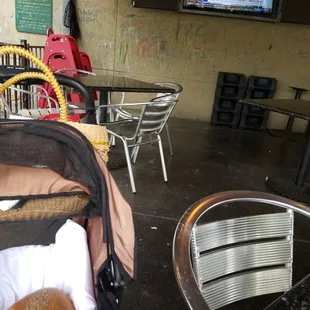 a baby in a stroller with a teddy bear