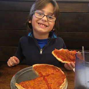 R enjoying a homestyle cheese personal pizza. He loved it (and he is VERY selective with his pizza)!