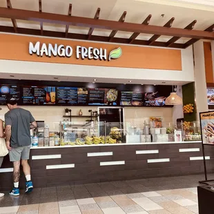 two people standing in front of the counter
