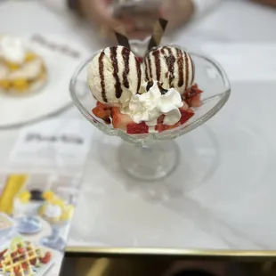 Strawberry Vanilla ice cream sundae with chocolate syrup. Very delicious