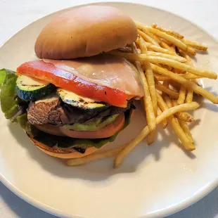 Grilled Vegetarian Sandwich with portabella mushroom, eggplant, zucchini, bell pepper, provolone, lettuce, tomorrow on house-made bun.