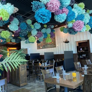 a restaurant decorated with pom poms