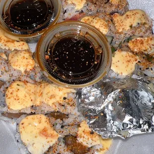 Spicy Basil Roll and Spicy Salmon Roll. Ginger and wasabi in the foil and soy sauce.