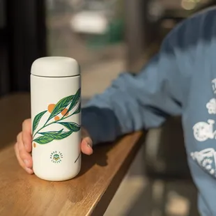 a person holding a coffee mug