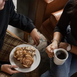 two women sharing a plate of pastries