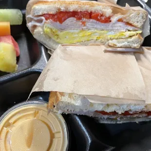 a sandwich with a side of fruit