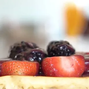 a waffle with berries and syrup