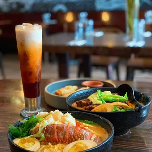 Lobster Tom yum Ramen (front) , Moo Red Curry Ramen (middle), crispy roll and chicken dumpling appetizer (back).
