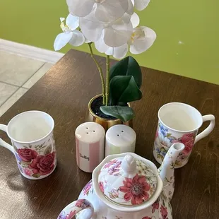 a table with a teapot and cups
