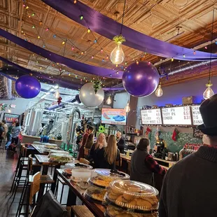 people sitting at tables in a restaurant