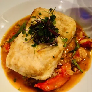 Halibut atop lobster meat in tomato broth