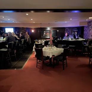 people sitting at tables in a restaurant