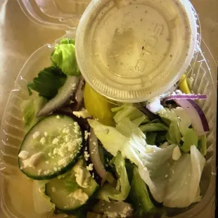 Two slices of cucumber, two tiny peppers and NO OLIVES on this $6 Greek salad.