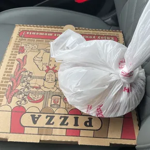 a pizza box in the back of a car