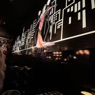 a woman in a red dress on a large screen