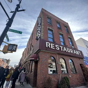 people walking in front of a restaurant
