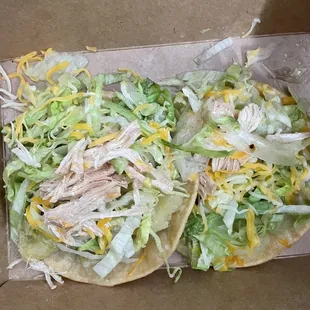 Chicken chalupa, with potatoes, lettuce, shredded cheese and salsa .