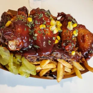 Hook em- fries, pulled pork, honey bbq wings topped with corn, and pickles