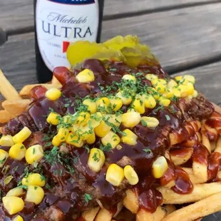 a plate of fries and a bottle of beer
