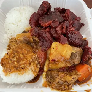 a plate of meat, rice, and vegetables